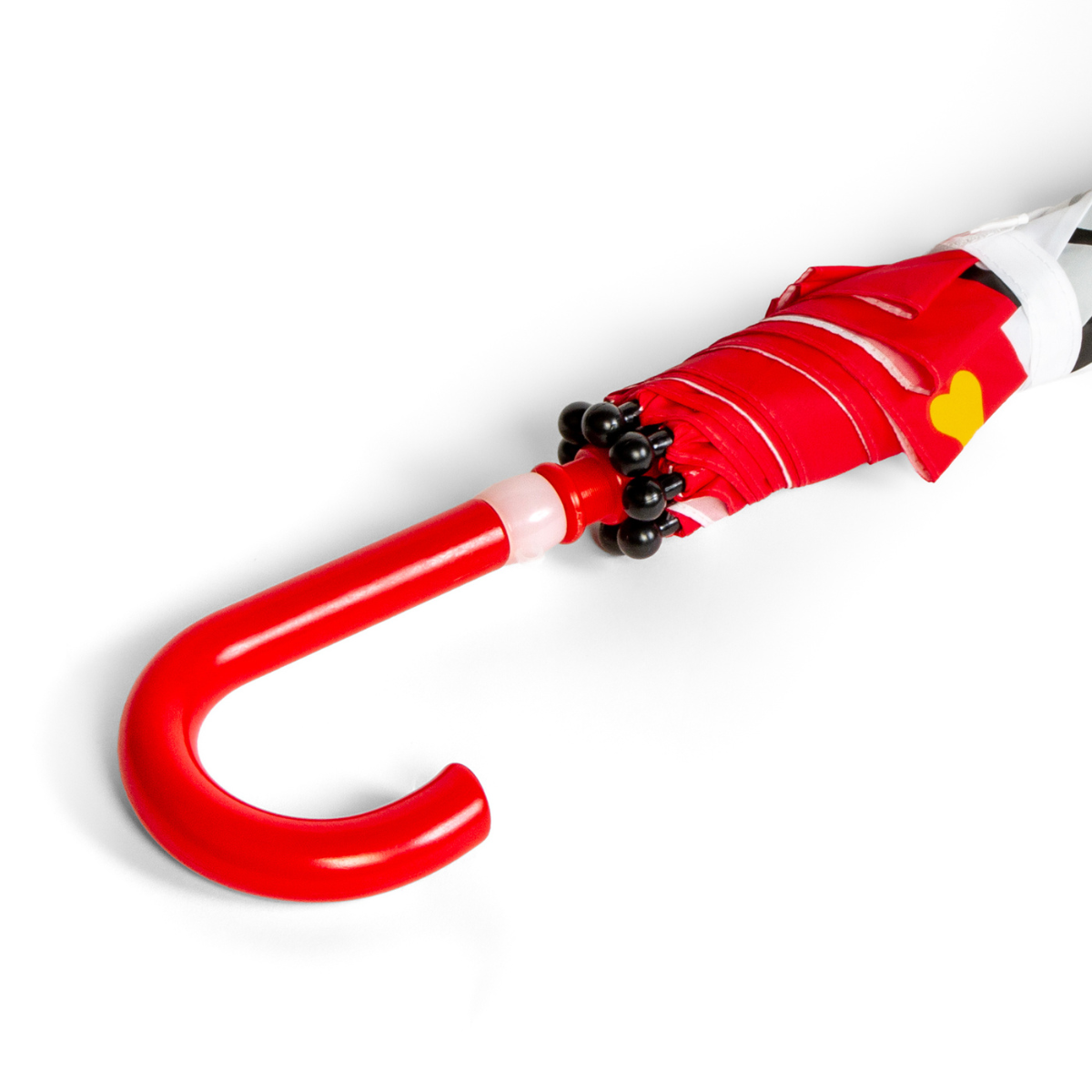 Red and white umbrella with a unique handle design on a white background