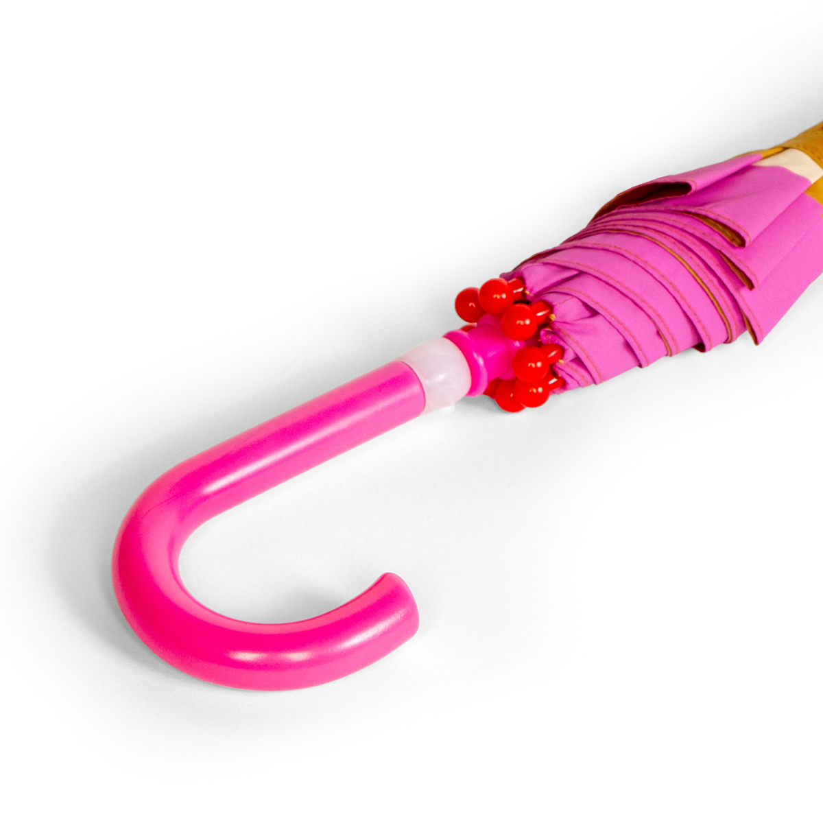 Close-up of a pink umbrella with a white handle on a light gray background